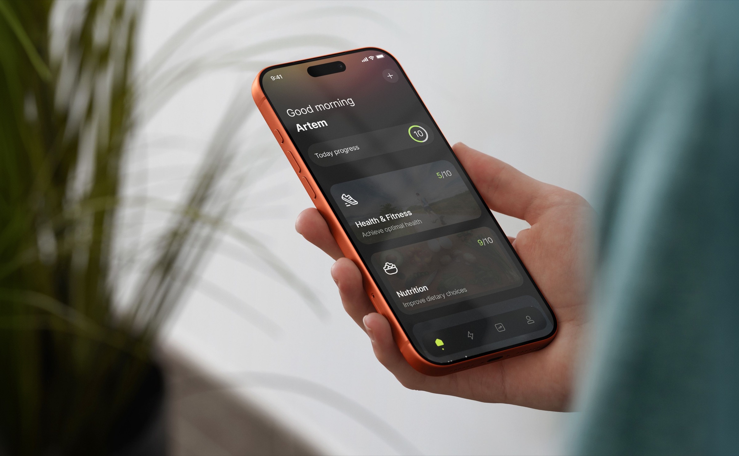 En hånd som holder en telefon som viser Motiway-appens skjerm for daglig fremgang